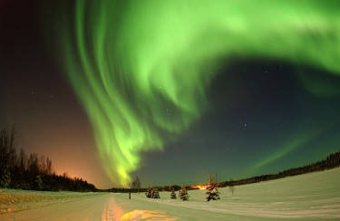 northern lights over snow field